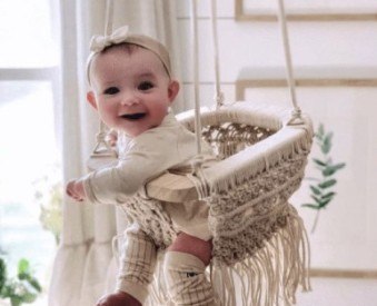 Finn Emma baby clothes-Baby swinging in Organic Macramé swing from the brand Finn Emma