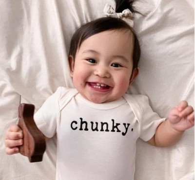 Finn Emma baby clothes-Smiling baby wearing graphic onesie 'Chunky'.