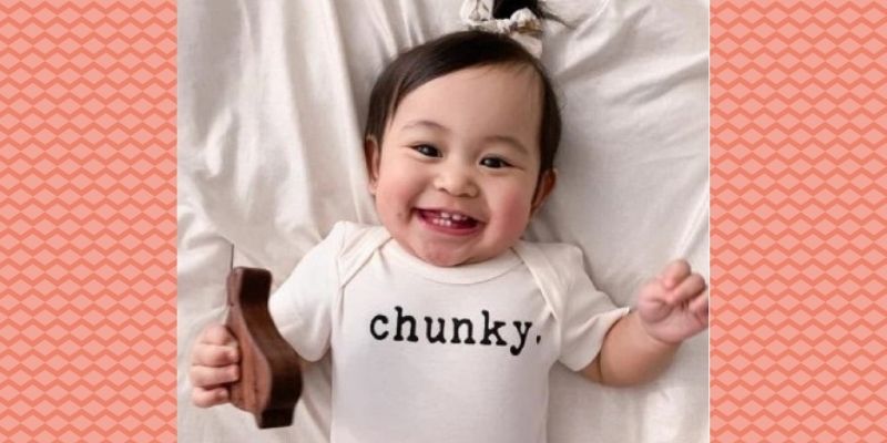 Finn Emma baby clothes-Smiling baby wearing Finn Emma graphic onesie 'Chunky'.