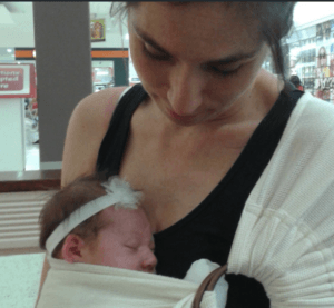 What is a baby sling?-Mum looking at baby inside the Hug a bub baby sling