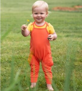 What is Oeko-Tex 10o certified mean?-Baby wearing orange Oeko-Tex 100 cetified playsuit