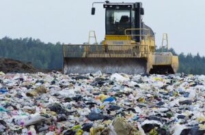 Would you consider renting baby clothes for a newborn?-Machinery working on landfill side.