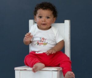 Best gender neural baby clothes-Baby wearing a organic colorful gender neutral outfit.