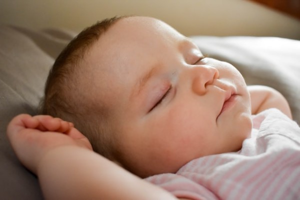Affordable organic baby clothes in Australia-Sleeping Newborn baby wearing white with pink stripped outfits.