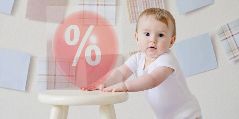 Does Baby Bunting have Sales?-Toddler standing up holding a little stool with a red sales balloon..