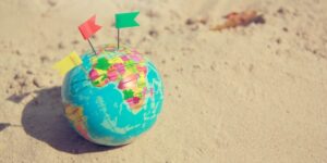 Where to buy Tea collection clothing?-World globe on sand.