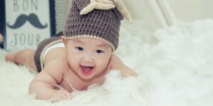 Shein baby clothes review.-Smiling Baby wearing a cute knitted outfit.